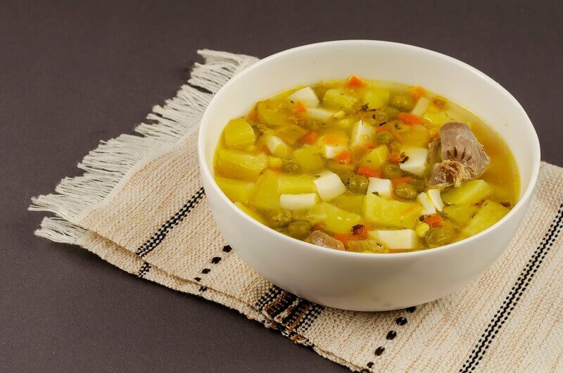 Rich chicken offal soup with spices: best with crunchy summer vegetables