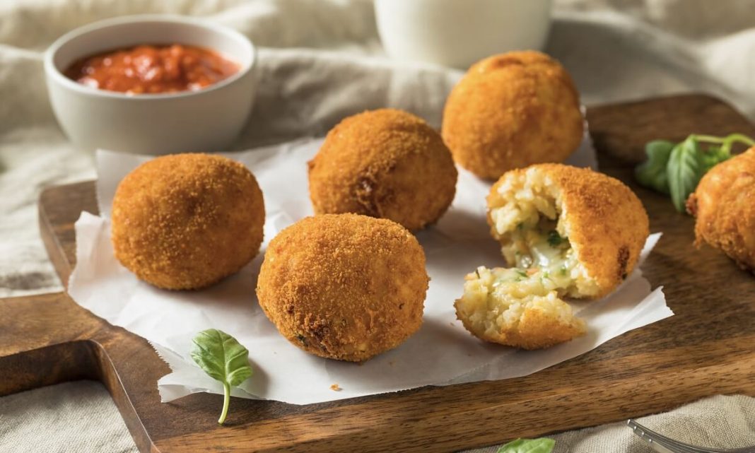Creamy Italian rice balls stuffed with cheese and flavored with basil